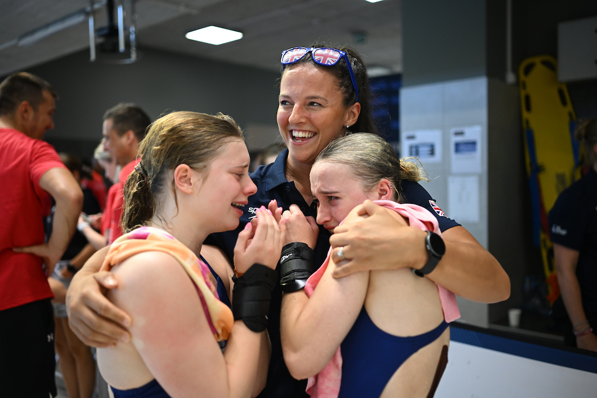 Head Coach at Sheffield Diving Club, Georgia Davenport, hugs two competitors