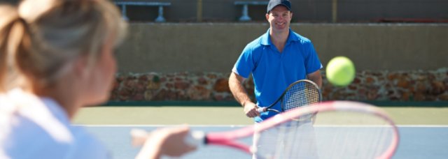 Adults playing tennis