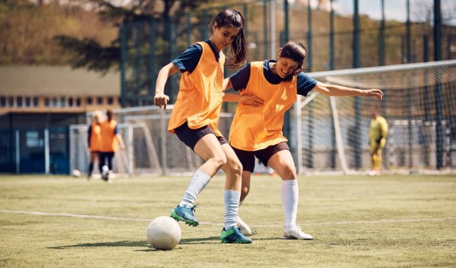 Young women playing football