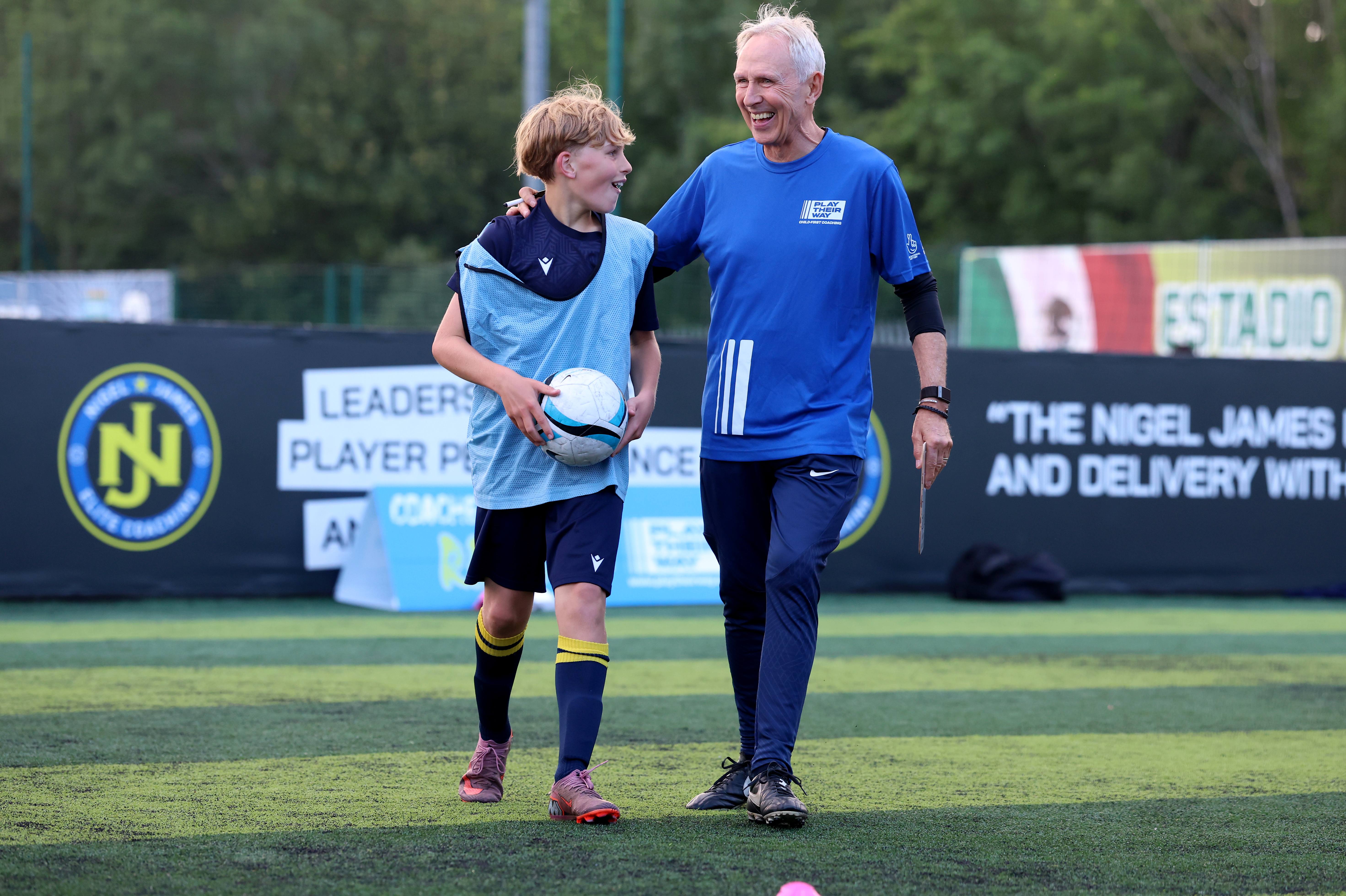 A participant and coach in coversation at the Nigel James Elite Coaching academy event with Play Their Way