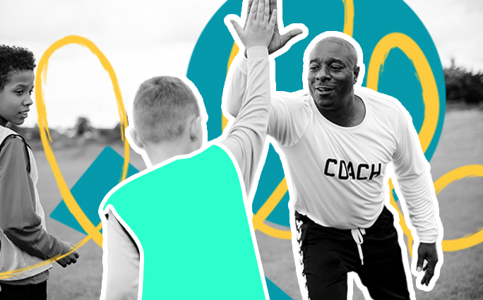 A coach high fives a young participant during a coaching session.