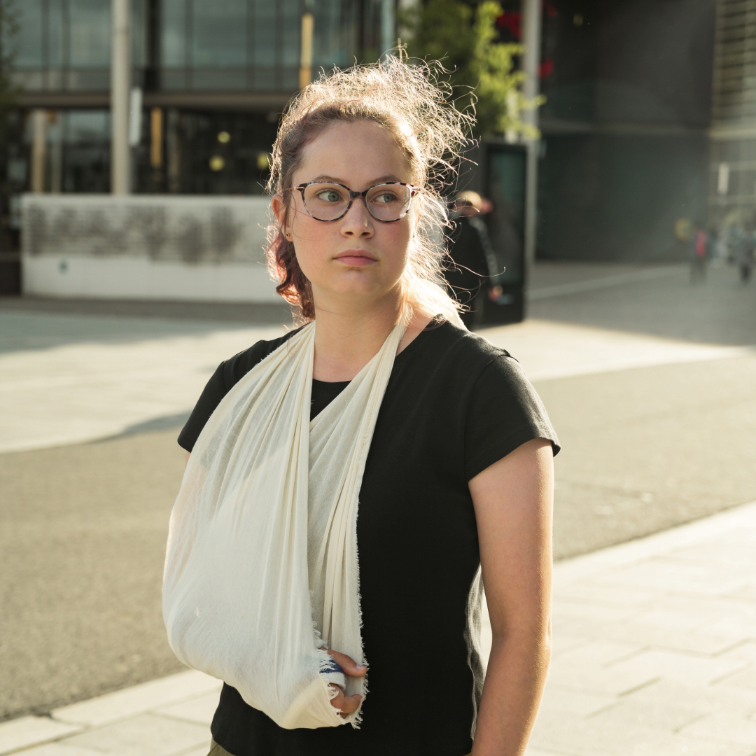 A girl with her right arm in a sling