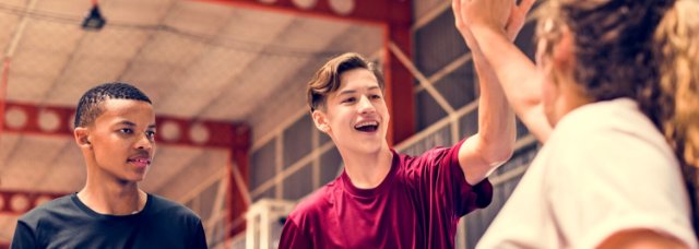 Smiling young people, two high fiving