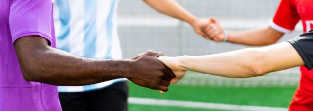 Sports team holding hands in a circle