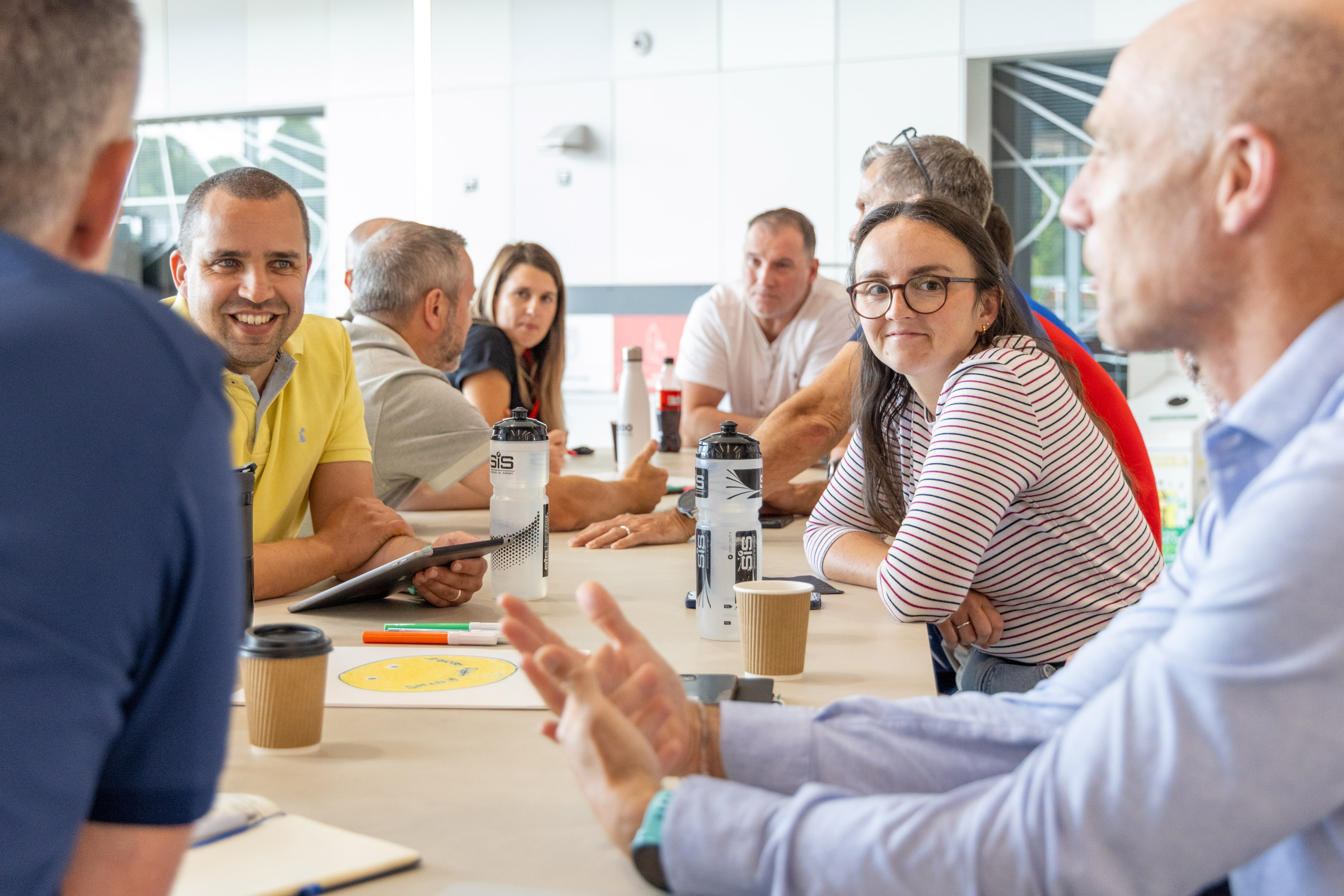 A group of people sat at a desk discussing a topic.